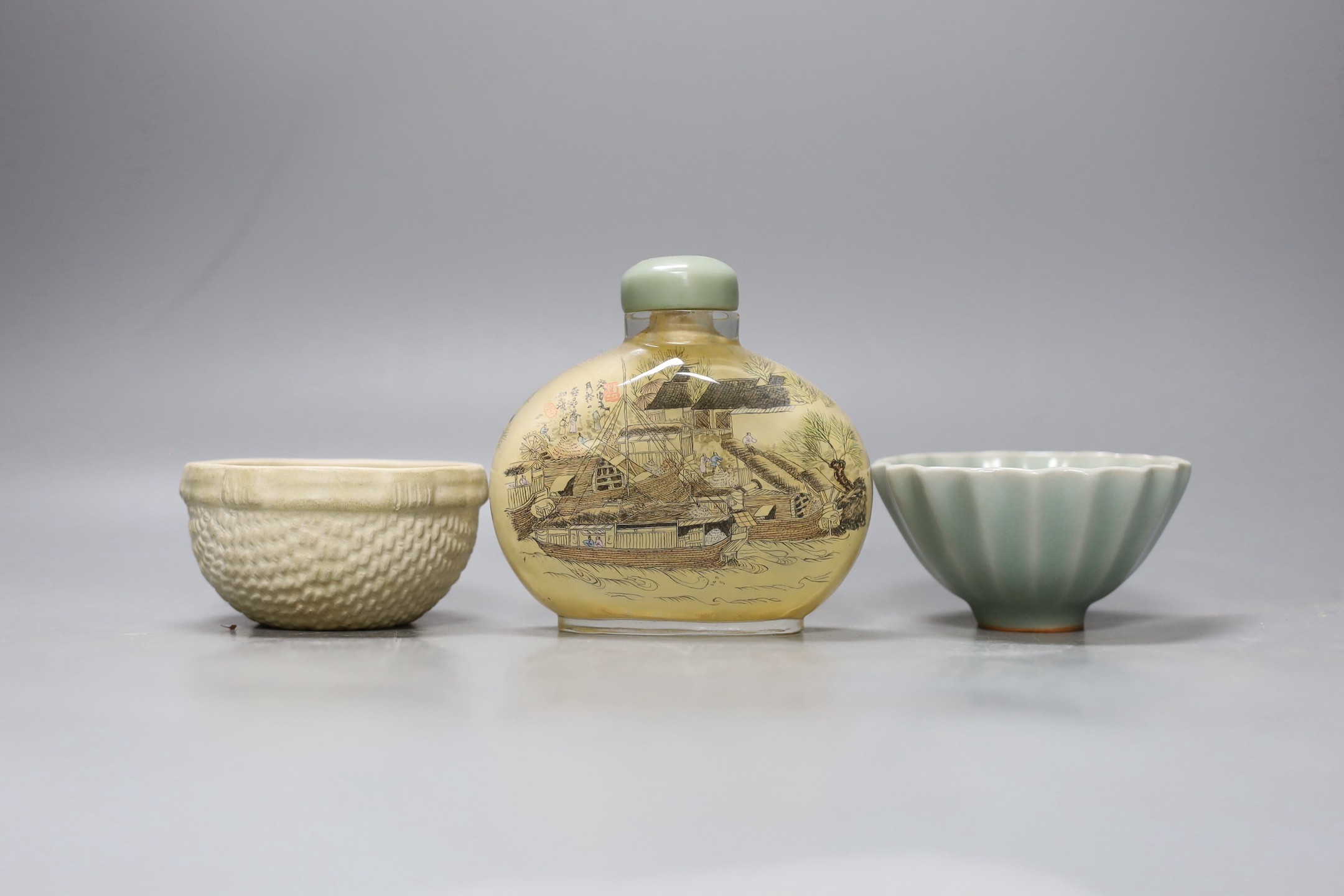 A Chinese inside-painted glass snuff bottle and cover, 10cm high, a Chinese Ming type basketware cup and a Chinese celadon fluted cup